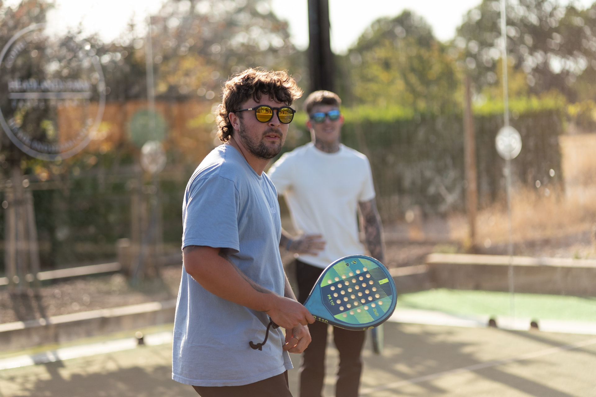 Men playing padel at a NERVA community event at Headlands Farm, Hampshire