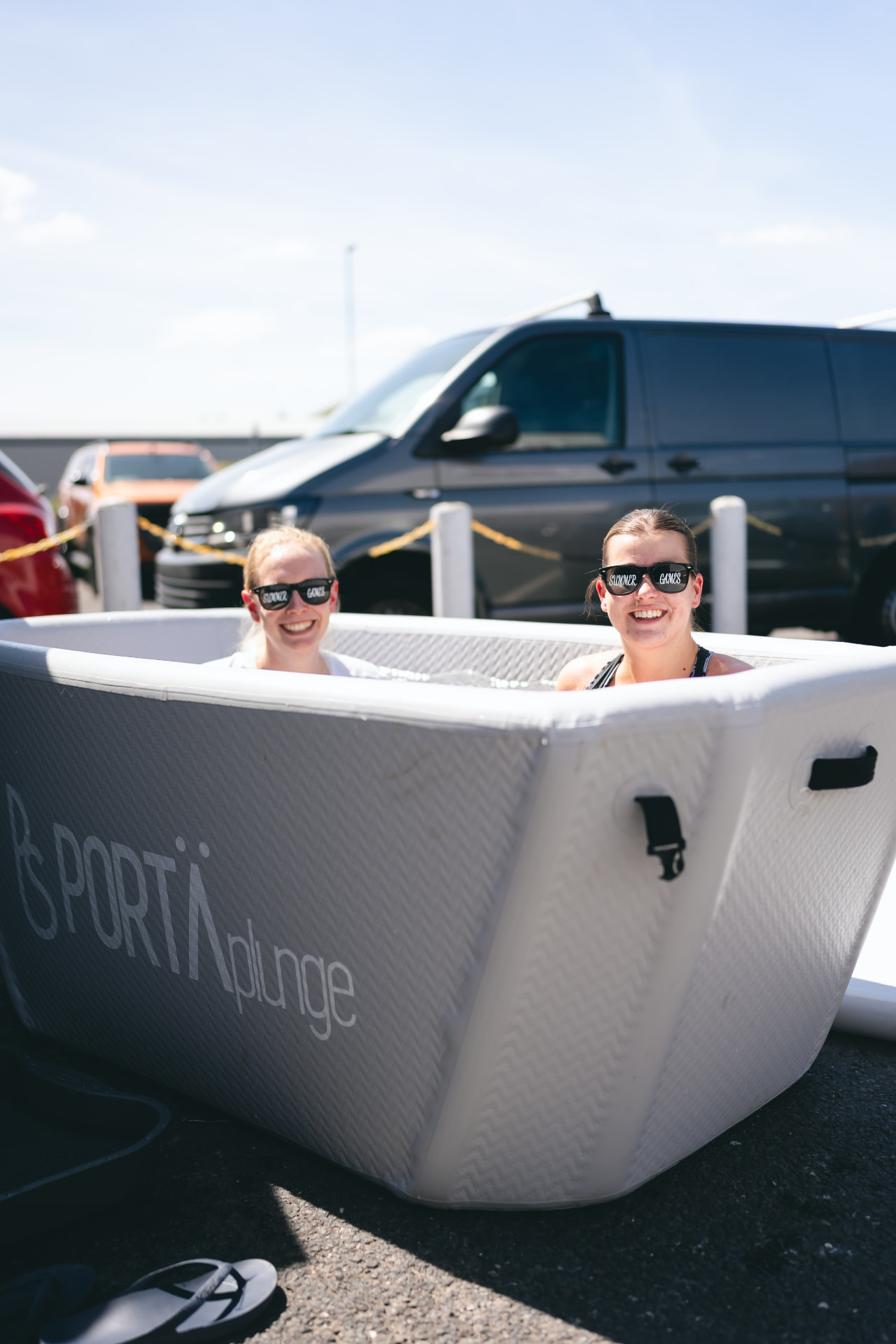 Two people in the PortaPlunge cold bath at a NERVA pop-up event in Hampshire
