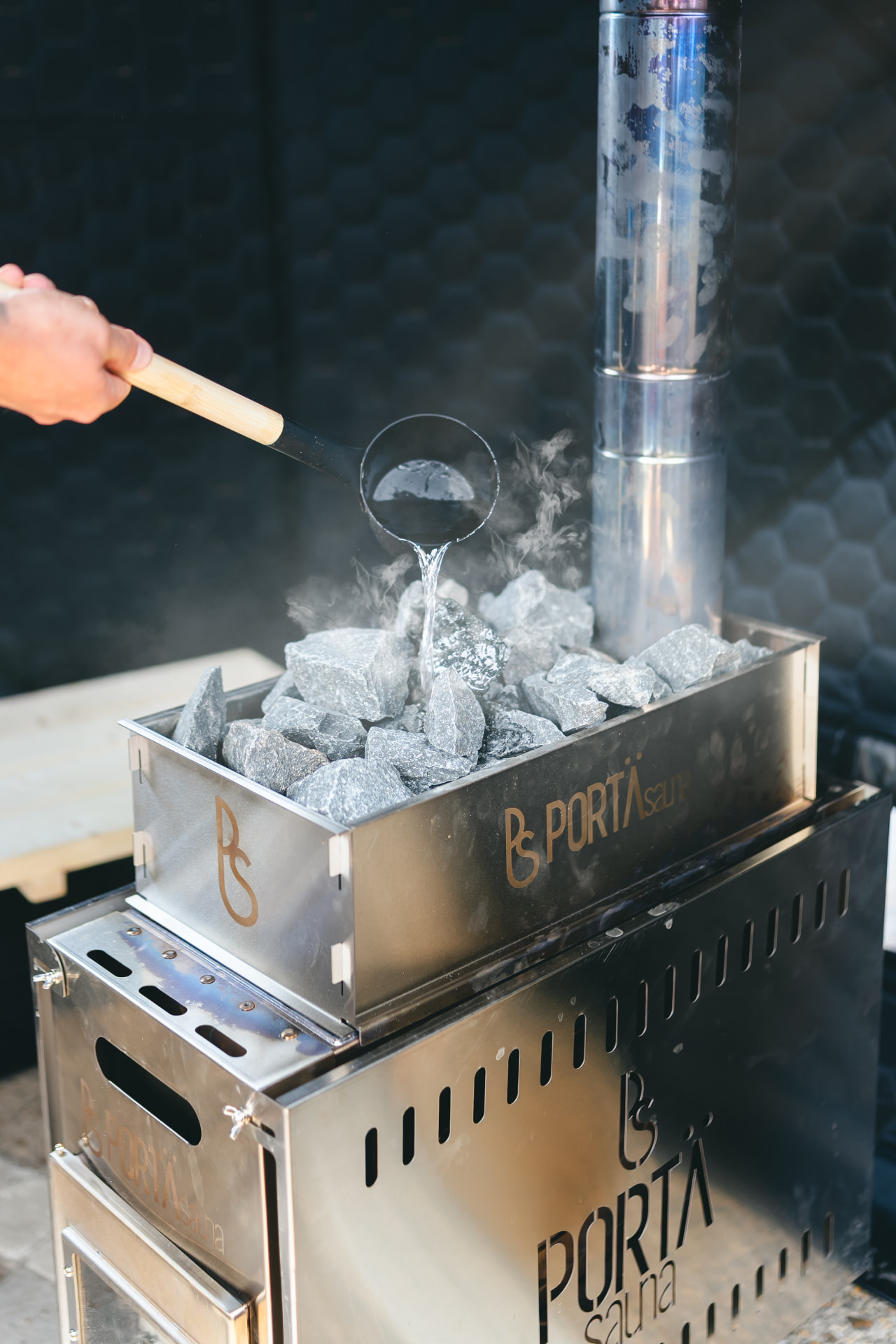 Water poured over hot sauna stones during a NERVA pop-up session in Hampshire